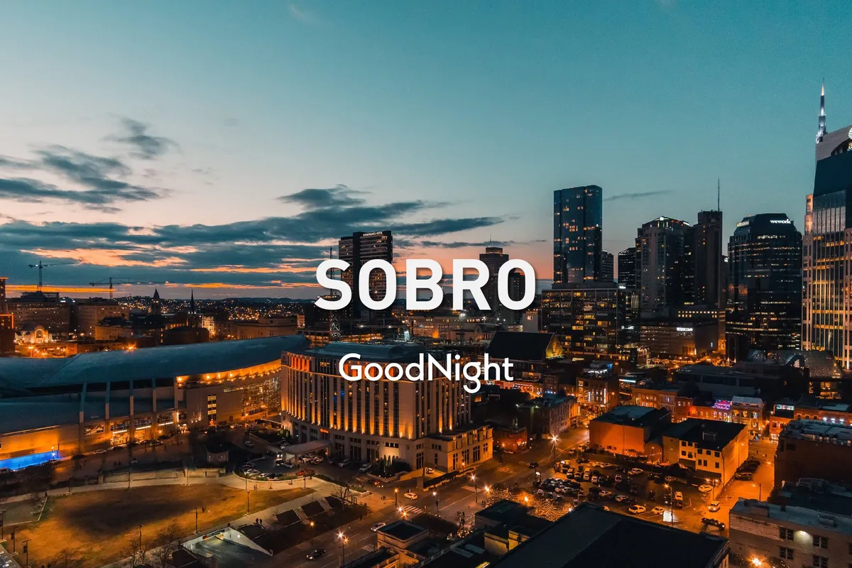 A sweeping cityscape at dusk showcases the Nashville skyline, glowing buildings, and animated street life below. The scene radiates the energetic nightlife atmosphere, suggesting a city that comes alive after dark.