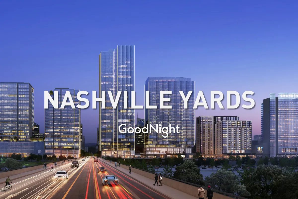 A nighttime cityscape featuring Nashville’s downtown skyscrapers and illuminated roadways. The setting is energetic, with hints of nearby restaurants, business venues, and the vibrant atmosphere of the West End corridor.